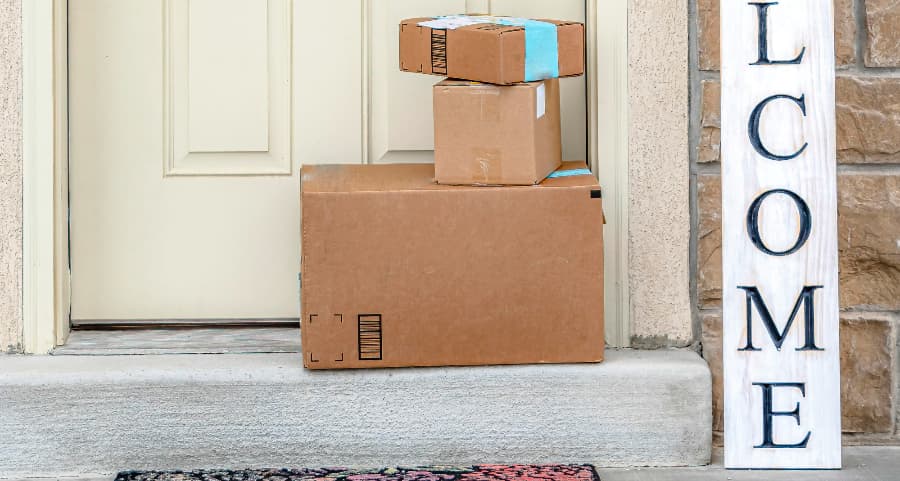 Deliveries on the front porch of a house with a welcome sign in Raleigh